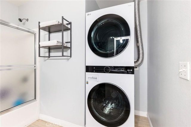 1180 Civic Center Dr Unit B21, Oceanside, CA 92054 - laundry area featuring stacked washer and clothes dryer and baseboards