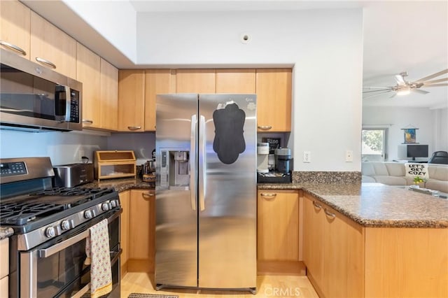 1180 Civic Center Dr Unit B21, Oceanside, CA 92054 - kitchen featuring appliances with stainless steel finishes, light brown cabinets, dark stone countertops, a peninsula, and open floor plan