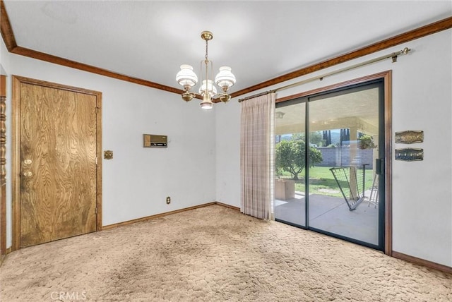 carpeted empty room with baseboards, ornamental molding, and an inviting chandelier