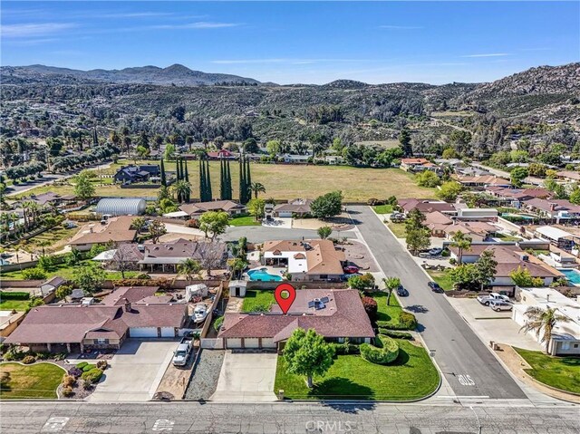 drone / aerial view featuring a residential view and a mountain view