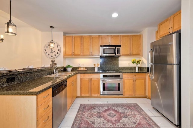 1150 J St Unit 117, San Diego, CA 92101 - kitchen with stainless steel appliances, a sink, light tile patterned flooring, a peninsula, and hanging light fixtures