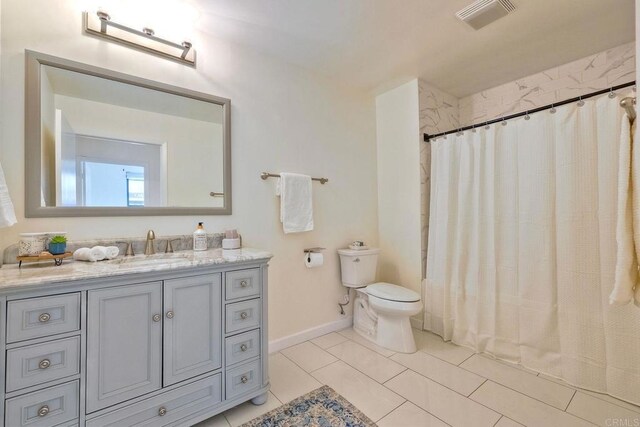 1150 J St Unit 117, San Diego, CA 92101 - bathroom featuring toilet, vanity, baseboards, and a shower with shower curtain