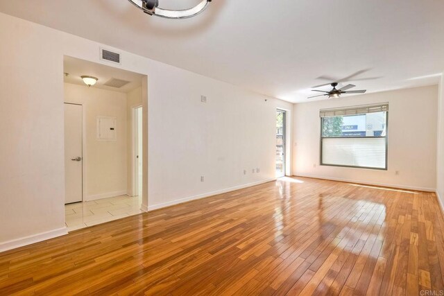 1150 J St Unit 117, San Diego, CA 92101 - empty room with light wood-style floors, ceiling fan, and baseboards