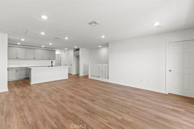 4265 S Hermosa Paseo, Ontario, CA 91761 - unfurnished living room with visible vents, light wood-style flooring, recessed lighting, and baseboards