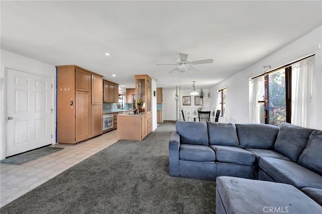 living room featuring light colored carpet, a ceiling fan, and recessed lighting