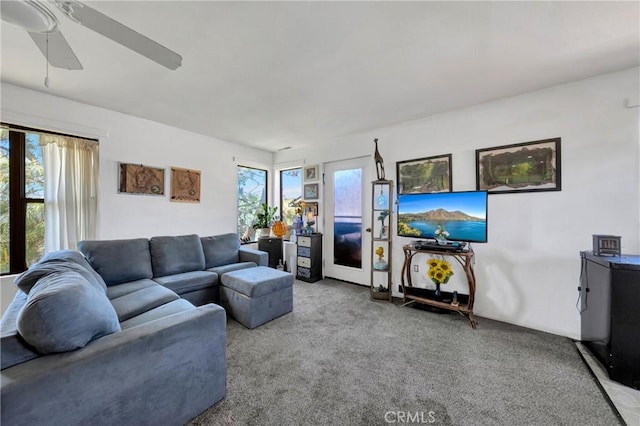 living area with carpet floors and a ceiling fan