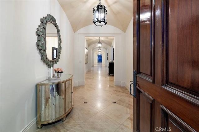 2258 Channel Rd, Newport Beach, CA 92661 - foyer entrance with baseboards, a chandelier, vaulted ceiling, and light tile patterned floors