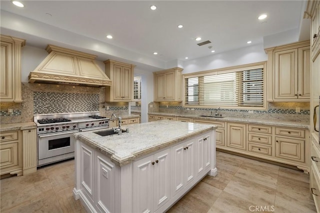 2258 Channel Rd, Newport Beach, CA 92661 - kitchen with range with two ovens, cream cabinets, a sink, custom range hood, and recessed lighting