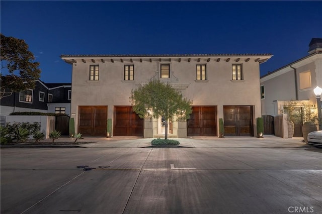 2258 Channel Rd, Newport Beach, CA 92661 - mediterranean / spanish-style home with a garage, stucco siding, concrete driveway, and a gate