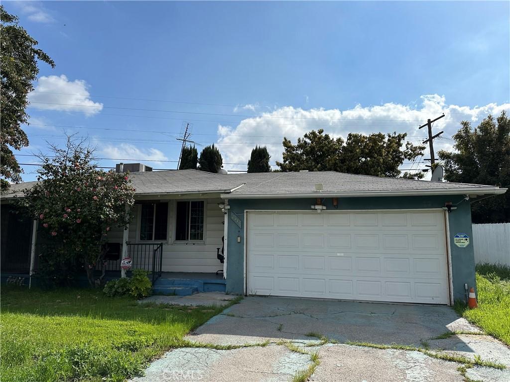 6415 Charlesworth Ave, North Hollywood, CA 91606 - ranch-style house featuring concrete driveway, a front lawn, and an attached garage