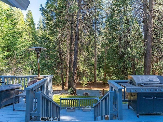 wooden deck with a wooded view