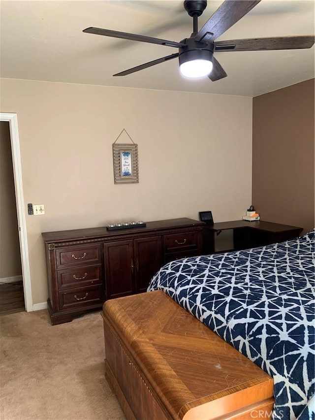 bedroom featuring light carpet, baseboards, and a ceiling fan