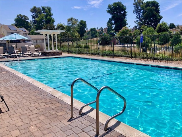 pool with fence and a patio area