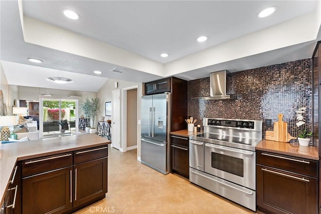 kitchen featuring dark brown cabinetry, wall chimney range hood, and stainless steel appliances