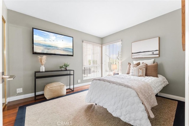 bedroom with baseboards and wood finished floors