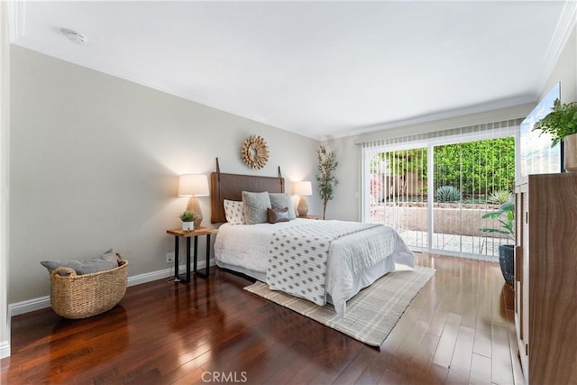 bedroom featuring crown molding, baseboards, wood finished floors, and access to exterior