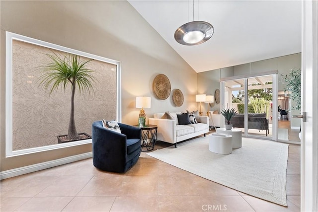 living area with tile patterned floors and high vaulted ceiling