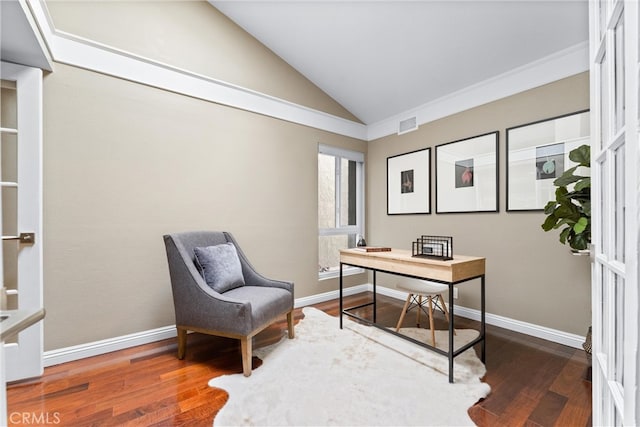 office area featuring wood finished floors, baseboards, lofted ceiling, and visible vents