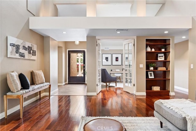 living room with wood-type flooring, baseboards, visible vents, and french doors