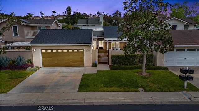multi unit property with an attached garage, stucco siding, concrete driveway, and a front yard