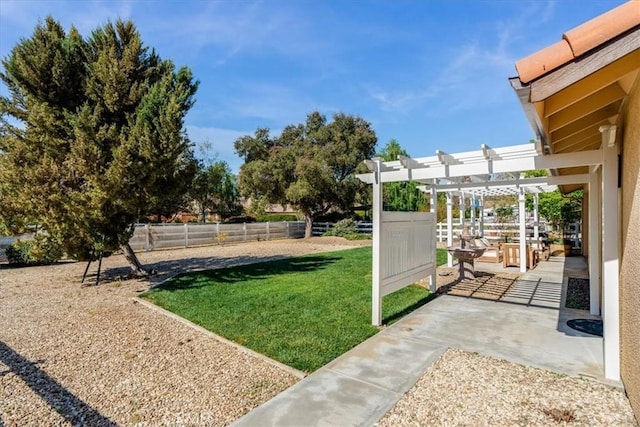 view of yard with a pergola, fence, and a patio area