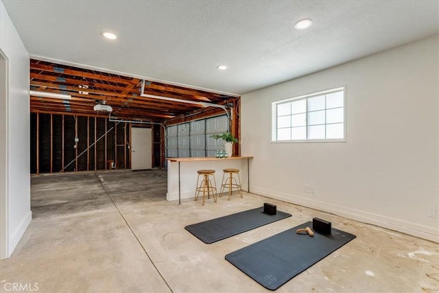 interior space with a garage, recessed lighting, and baseboards