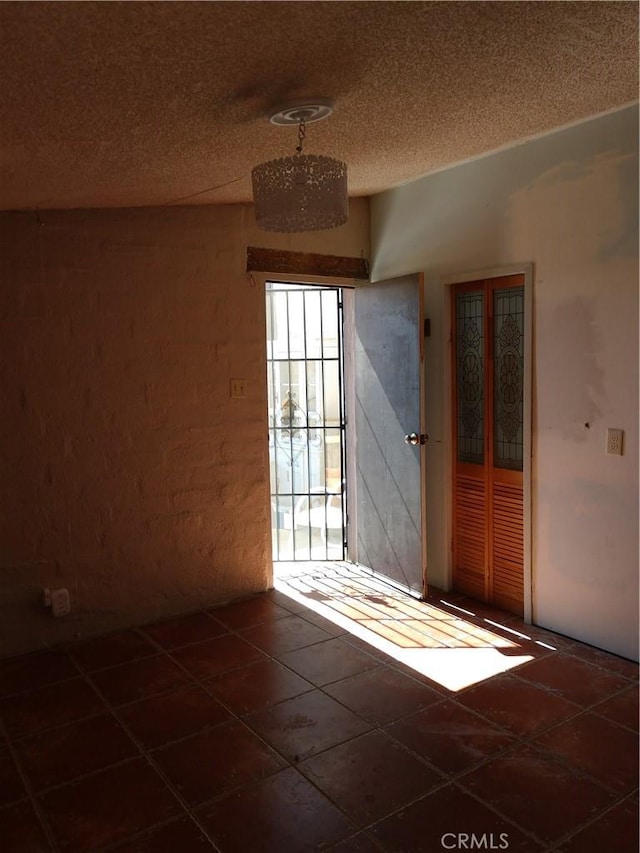 unfurnished room featuring a textured ceiling