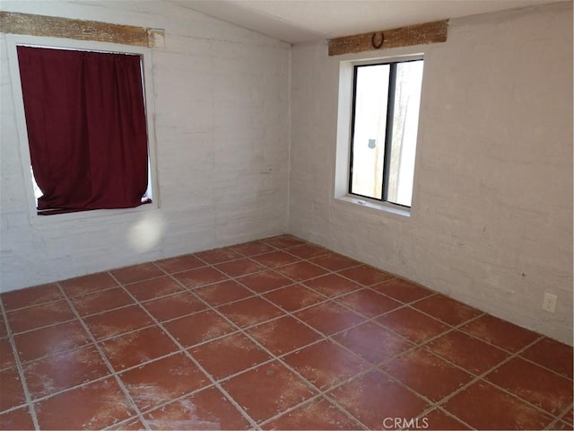 spare room featuring dark tile patterned flooring