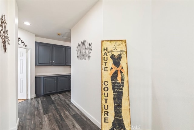 hallway featuring baseboards, dark wood finished floors, and recessed lighting