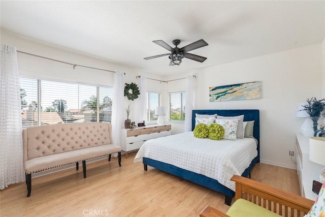 bedroom with light wood-style flooring and ceiling fan