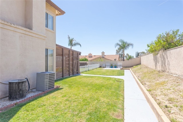 view of yard featuring a fenced backyard and central air condition unit