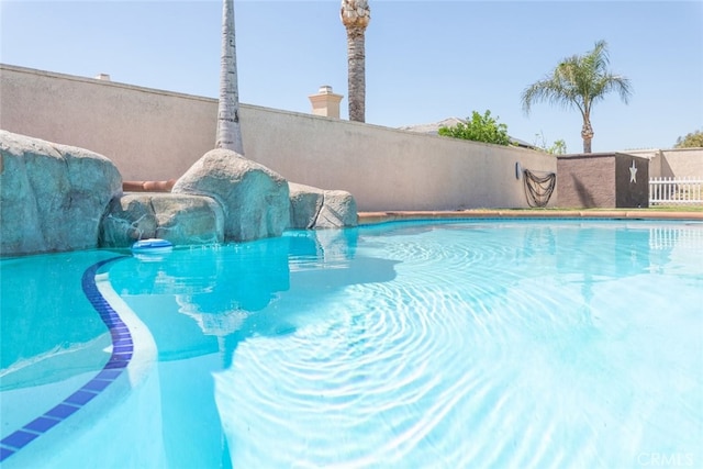view of pool with a fenced in pool