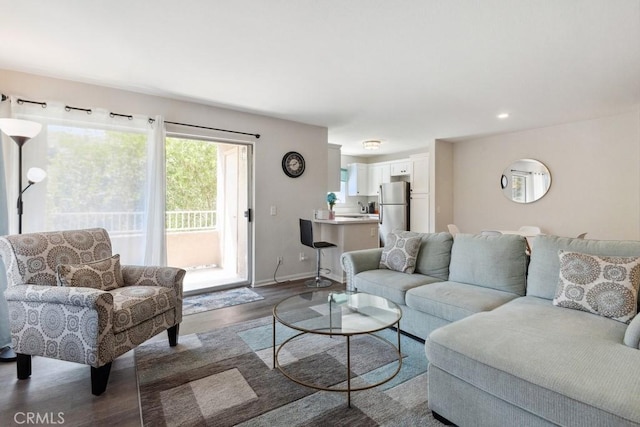 living area with recessed lighting, wood finished floors, and baseboards