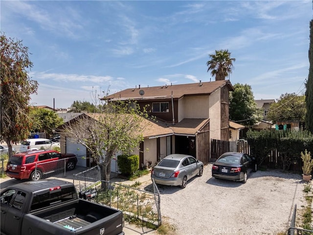 view of front of property with stucco siding and fence