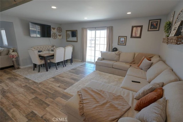 living area with recessed lighting, baseboards, and wood finished floors