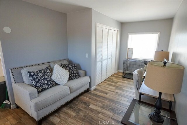 living room featuring wood finished floors and baseboards