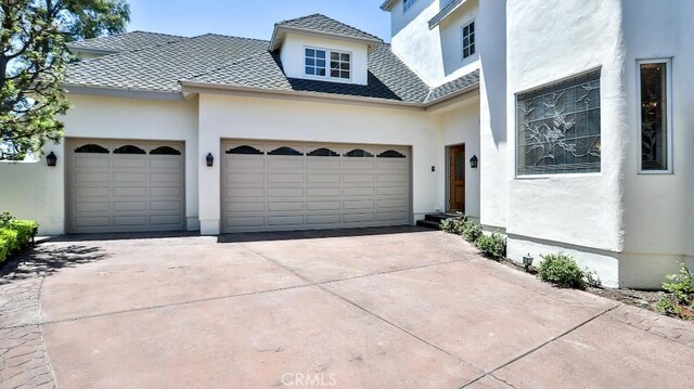 25782 Highplains Ter, Laguna Hills, CA 92653 - view of front of house featuring stucco siding, concrete driveway, a garage, and roof with shingles