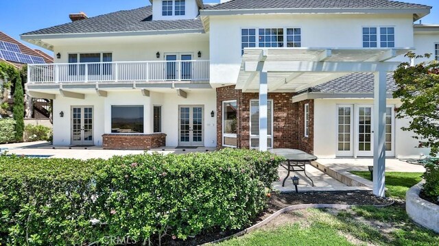 25782 Highplains Ter, Laguna Hills, CA 92653 - back of house with french doors, a balcony, stucco siding, a pergola, and a patio