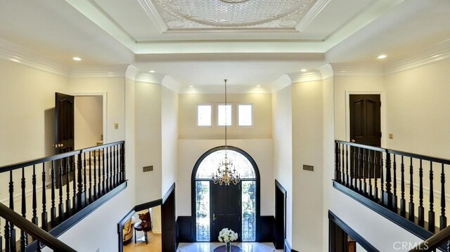 25782 Highplains Ter, Laguna Hills, CA 92653 - foyer featuring a chandelier, a raised ceiling, a towering ceiling, recessed lighting, and ornamental molding