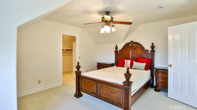 25782 Highplains Ter, Laguna Hills, CA 92653 - bedroom with light carpet, a walk in closet, vaulted ceiling, and a ceiling fan
