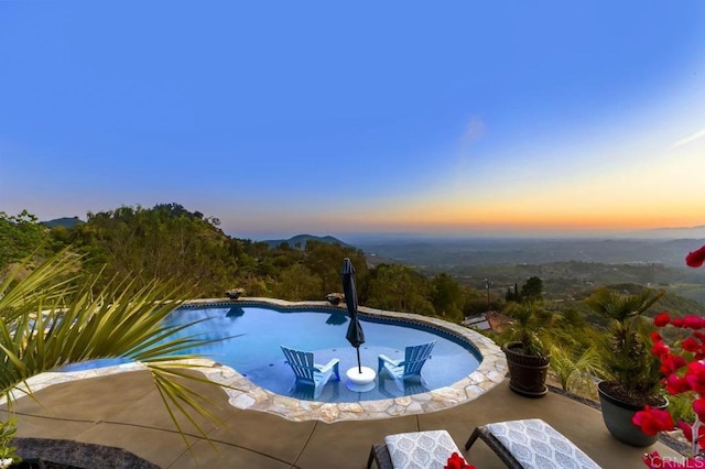 1078 Rainbow Crest Rd, Fallbrook, CA 92028 - pool at dusk featuring an outdoor pool and a patio