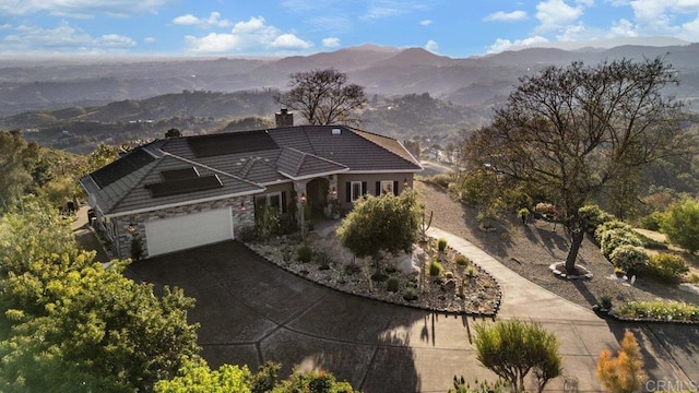 1078 Rainbow Crest Rd, Fallbrook, CA 92028 - view of front facade featuring a chimney, stone siding, roof mounted solar panels, and a mountain view