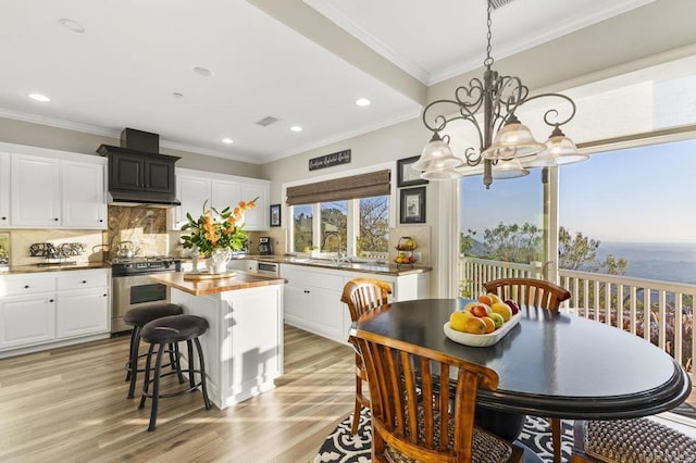 1078 Rainbow Crest Rd, Fallbrook, CA 92028 - kitchen featuring stainless steel gas stove, a chandelier, a sink, light wood-type flooring, and a kitchen island