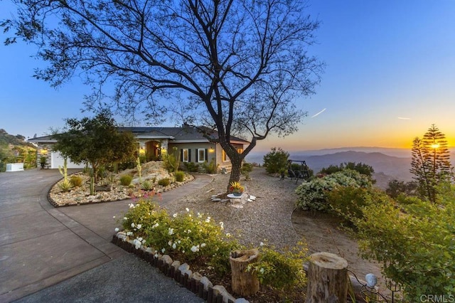 1078 Rainbow Crest Rd, Fallbrook, CA 92028 - view of front facade featuring roof mounted solar panels, curved driveway, and a mountain view