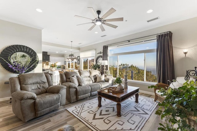 1078 Rainbow Crest Rd, Fallbrook, CA 92028 - living room featuring a ceiling fan, light wood-style flooring, ornamental molding, baseboards, and a chandelier