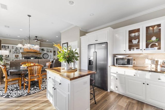 1078 Rainbow Crest Rd, Fallbrook, CA 92028 - kitchen with stainless steel appliances, wood counters, white cabinets, light wood finished floors, and crown molding