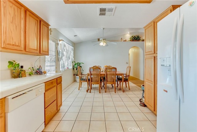 dining space featuring light tile patterned floors, visible vents, lofted ceiling, arched walkways, and ceiling fan