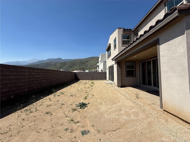 view of yard with a mountain view and a fenced backyard