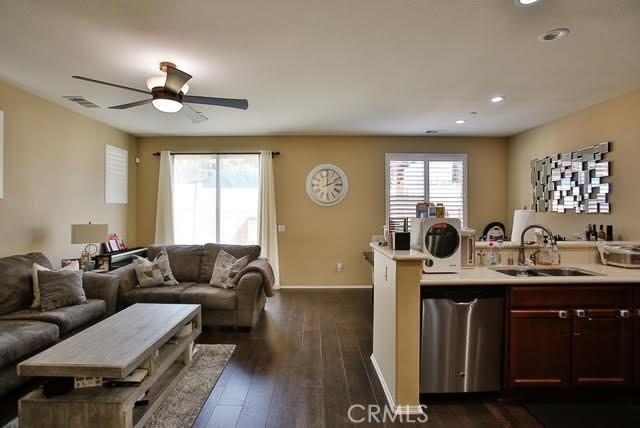 kitchen with a sink, light countertops, open floor plan, and a wealth of natural light