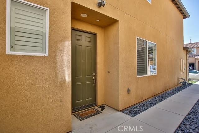 property entrance featuring stucco siding